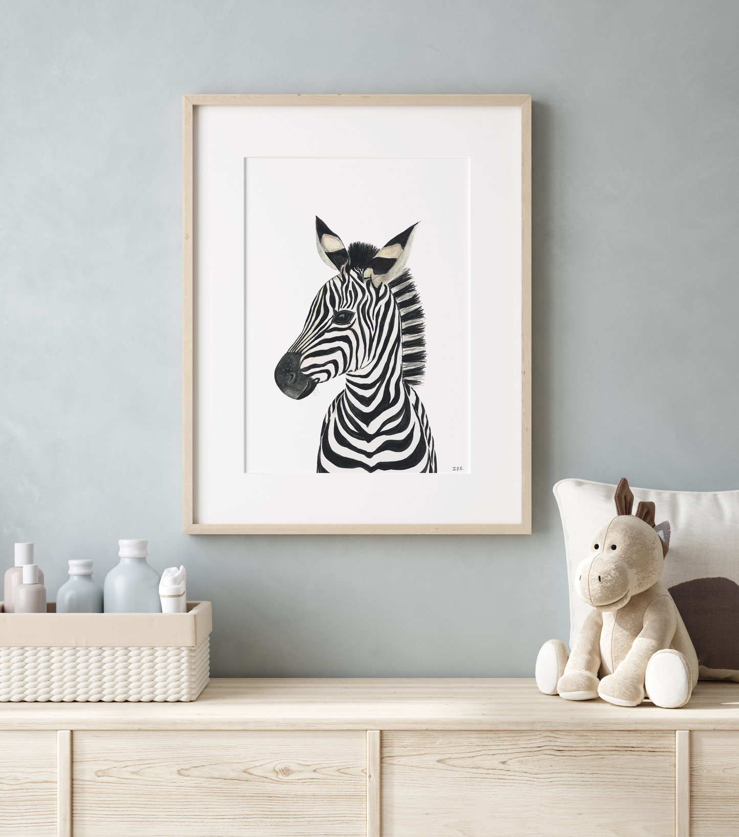 Framed zebra animal print in a nursery with decoration