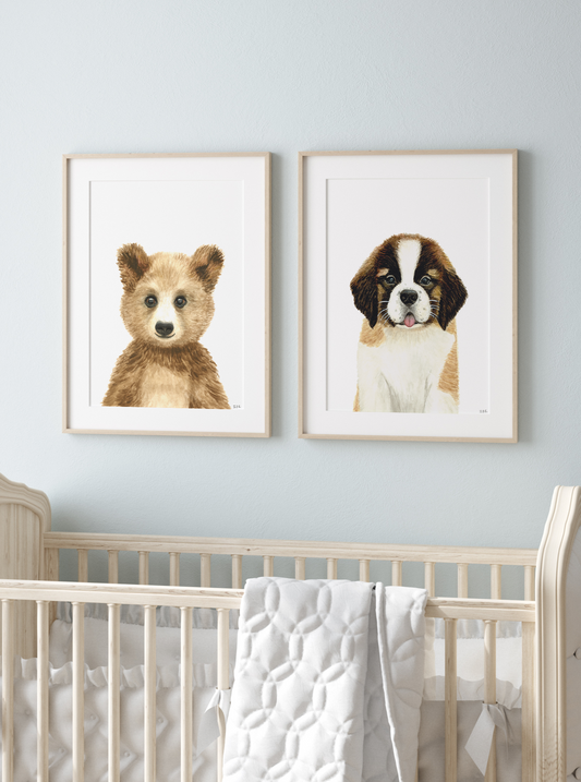 Zoomed in frames of a bear and St Bernard puppy nursery prints above a baby crib