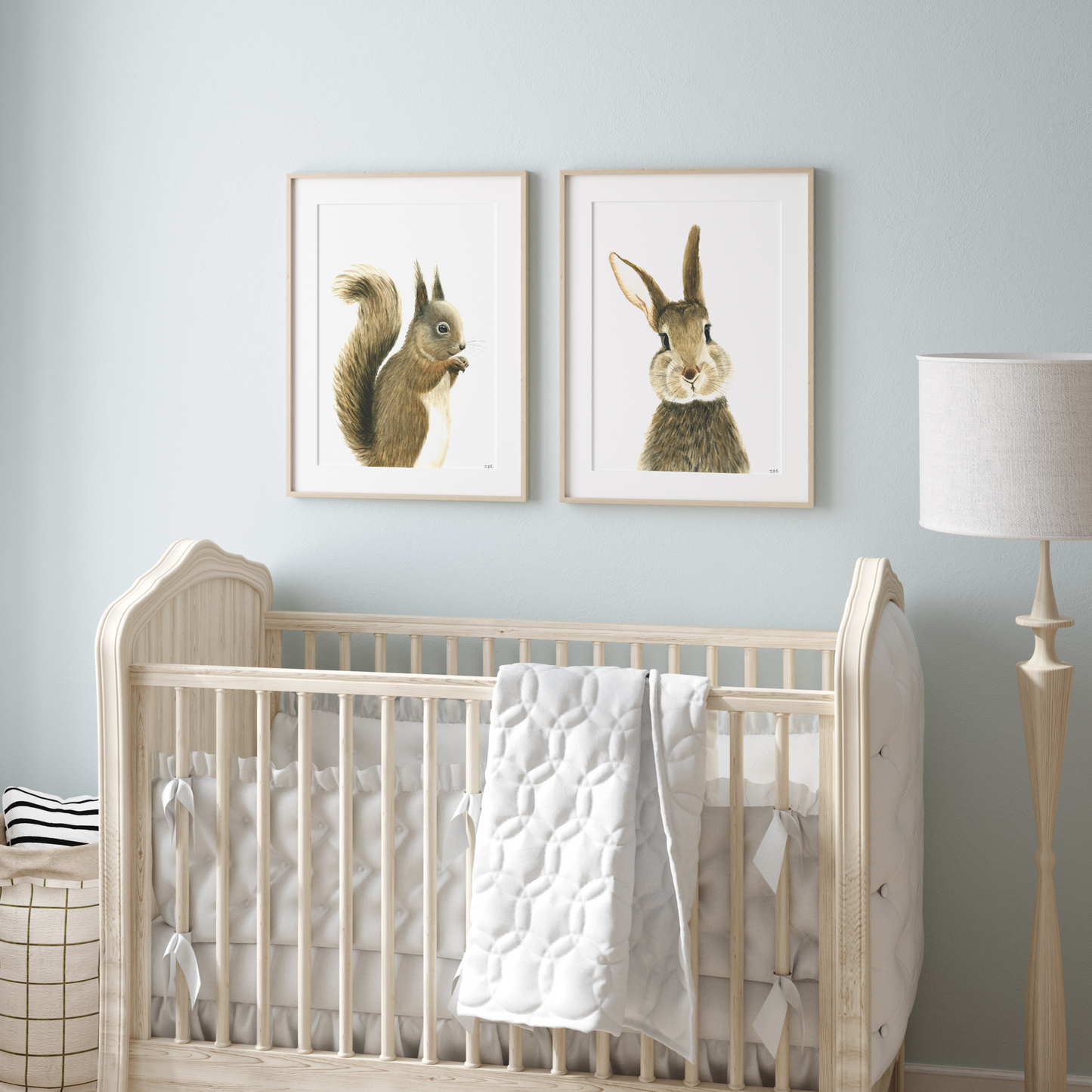 Set of 2 nursery animal prints above baby crib: squirrel and bunny rabbit