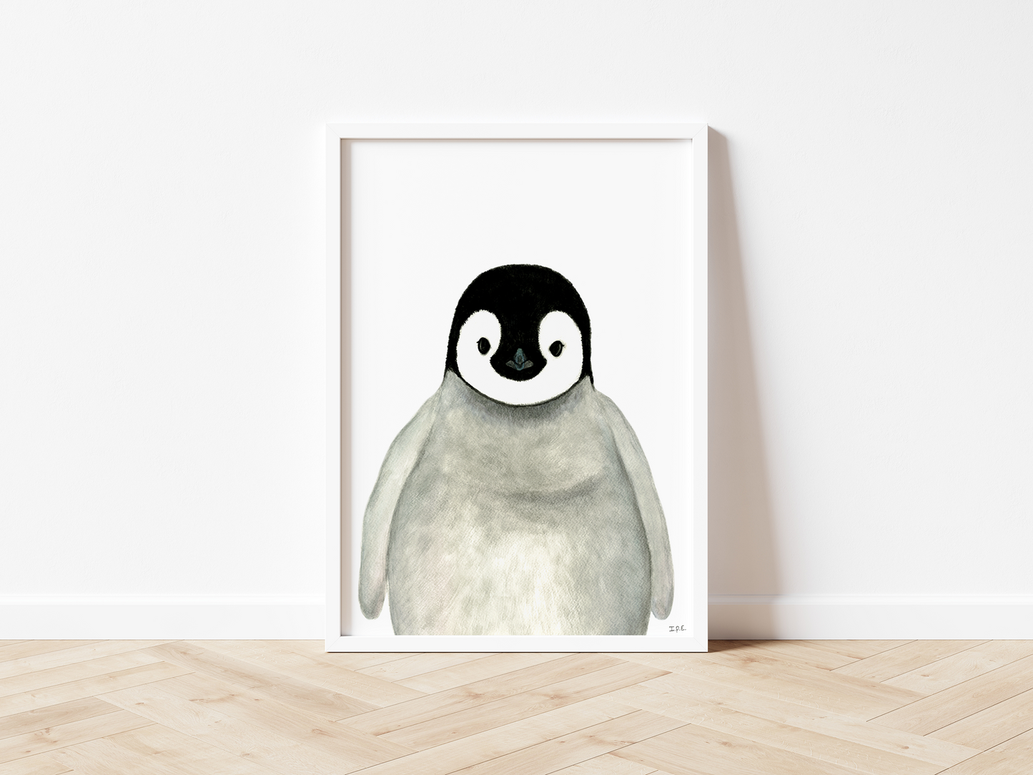 Framed penguin wall art print on wooden floor