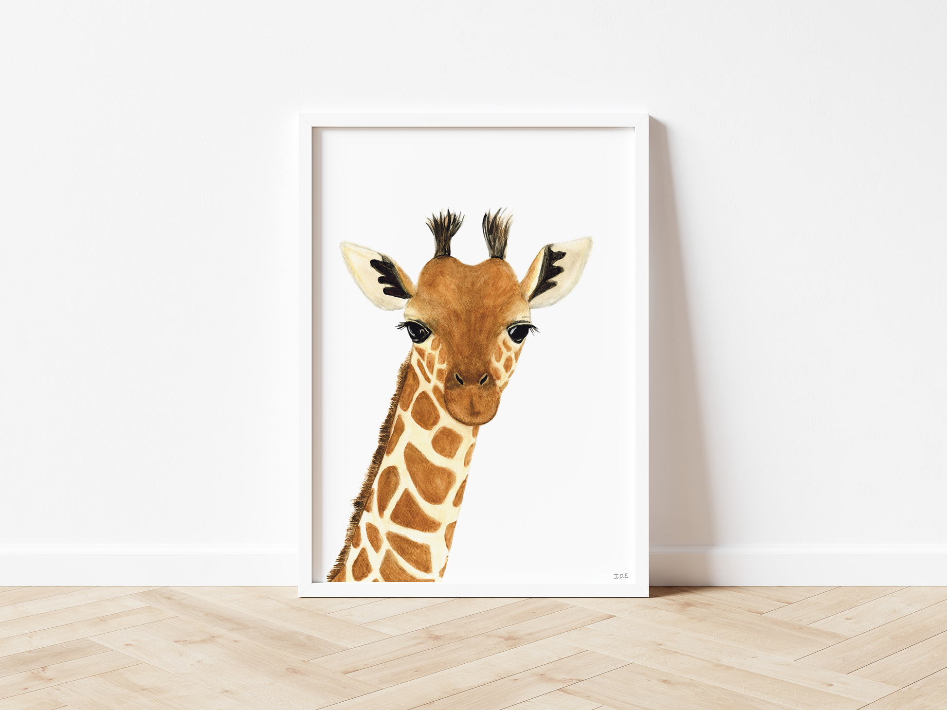 Framed giraffe nursery art on wooden floor